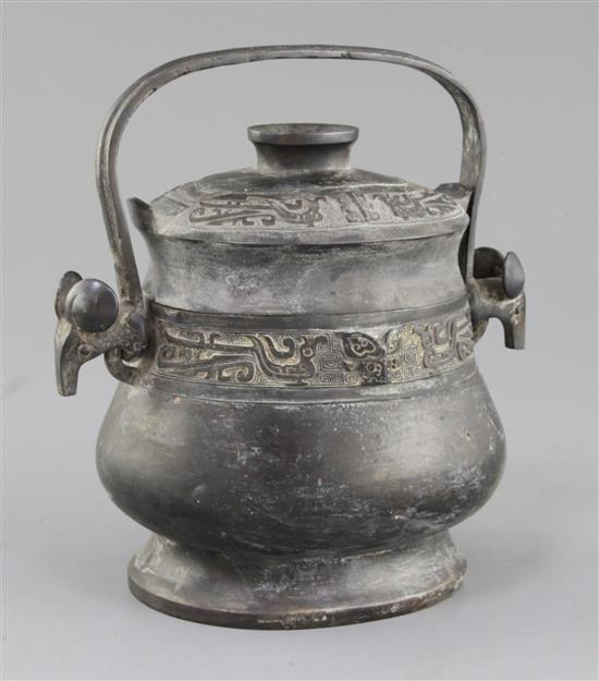 A Chinese archaic bronze ritual wine vessel and cover, You, late Shang/early Western Zhou dynasty, 11th century B.C., 22cm high, repair